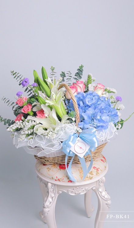 1 Hydrangea, 2 Stems Casablanca Lily, 3 Imported Roses and 4 Carnations with Statice in a Basket