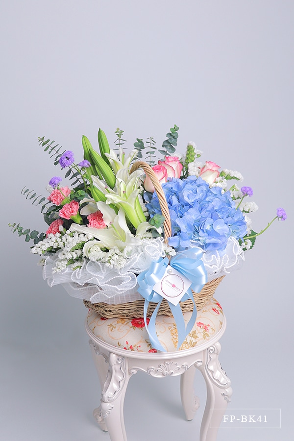 FP-BK41 1 Hydrangea, 2 Stems Casablanca Lily, 3 Imported Roses and 4 Carnations with Statice in a Basket