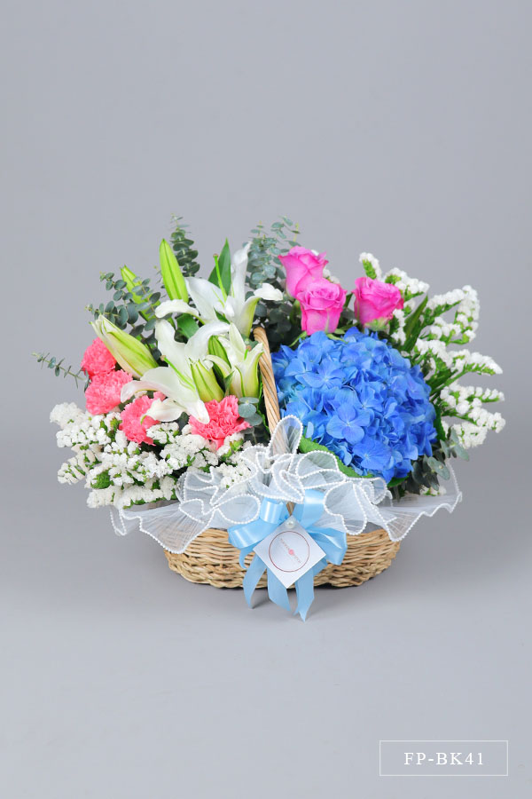 1 Hydrangea, 2 Stems Casablanca Lily, 3 Imported Roses and 4 Carnations with Statice in a Basket